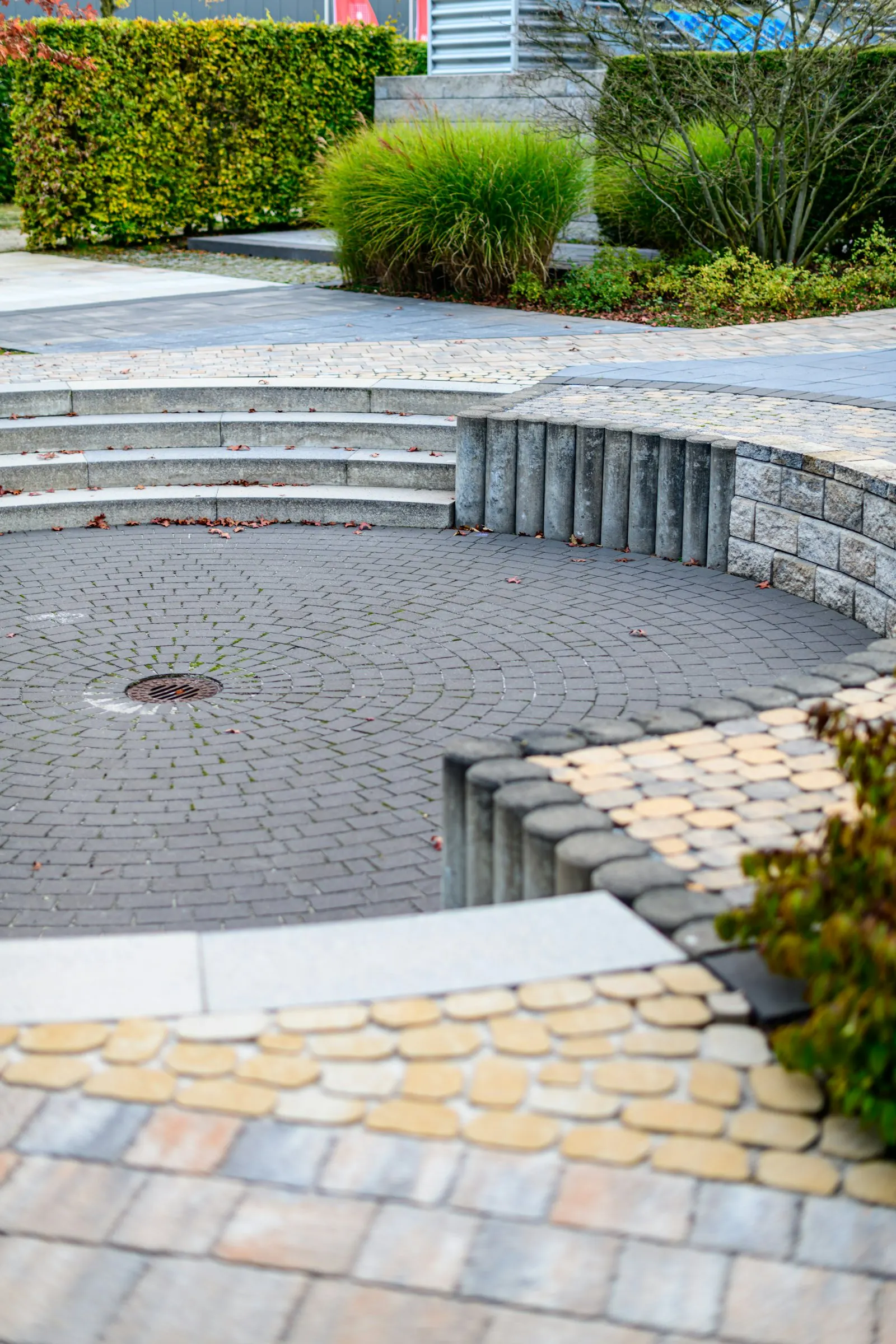 Curved paver patio with a low seat wall and desert plantings — Lake Havasu installation reference