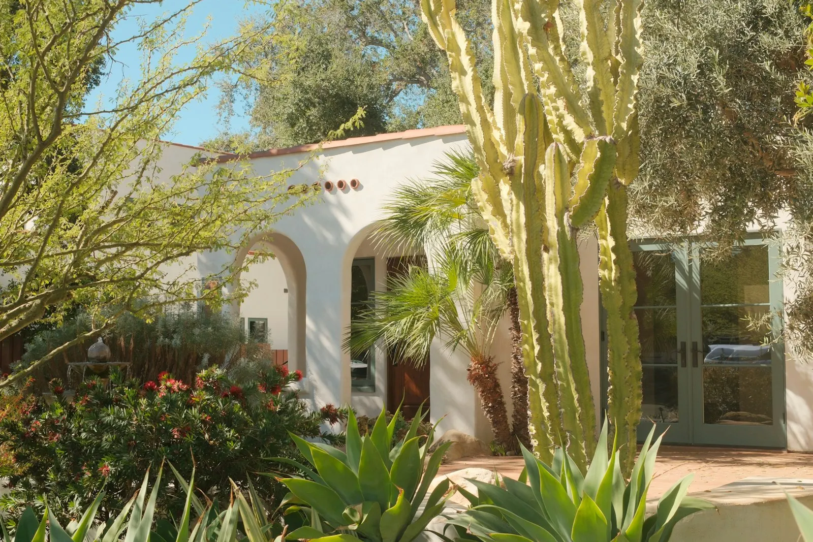 Spanish-style desert home with paver walkway and palms, Mohave County