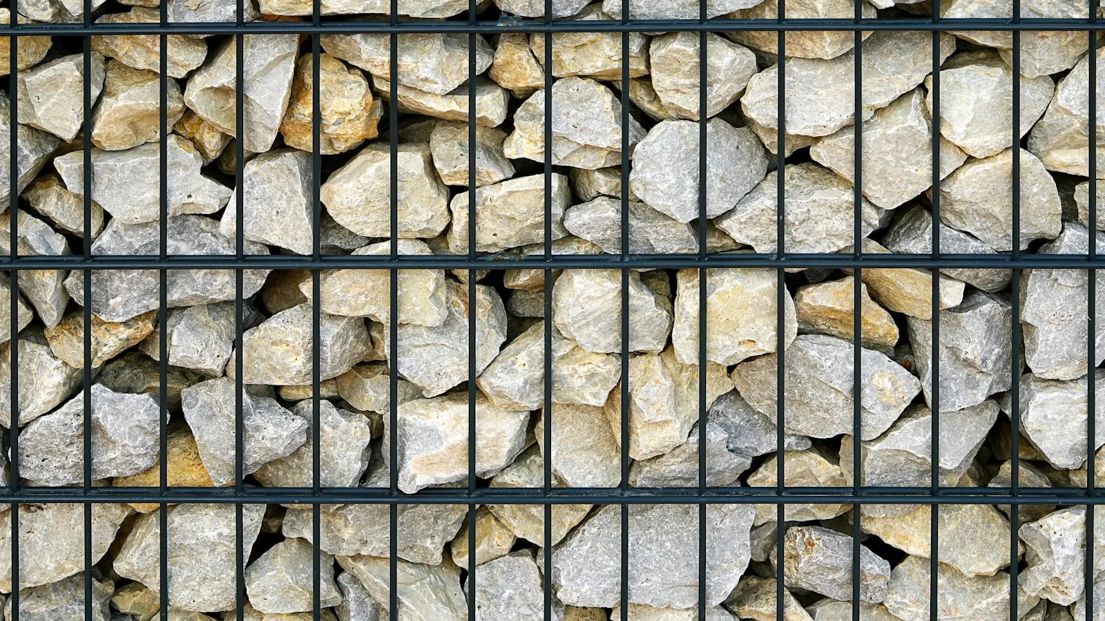 Tan block wall along a desert yard slope — reference for CMU privacy wall finish