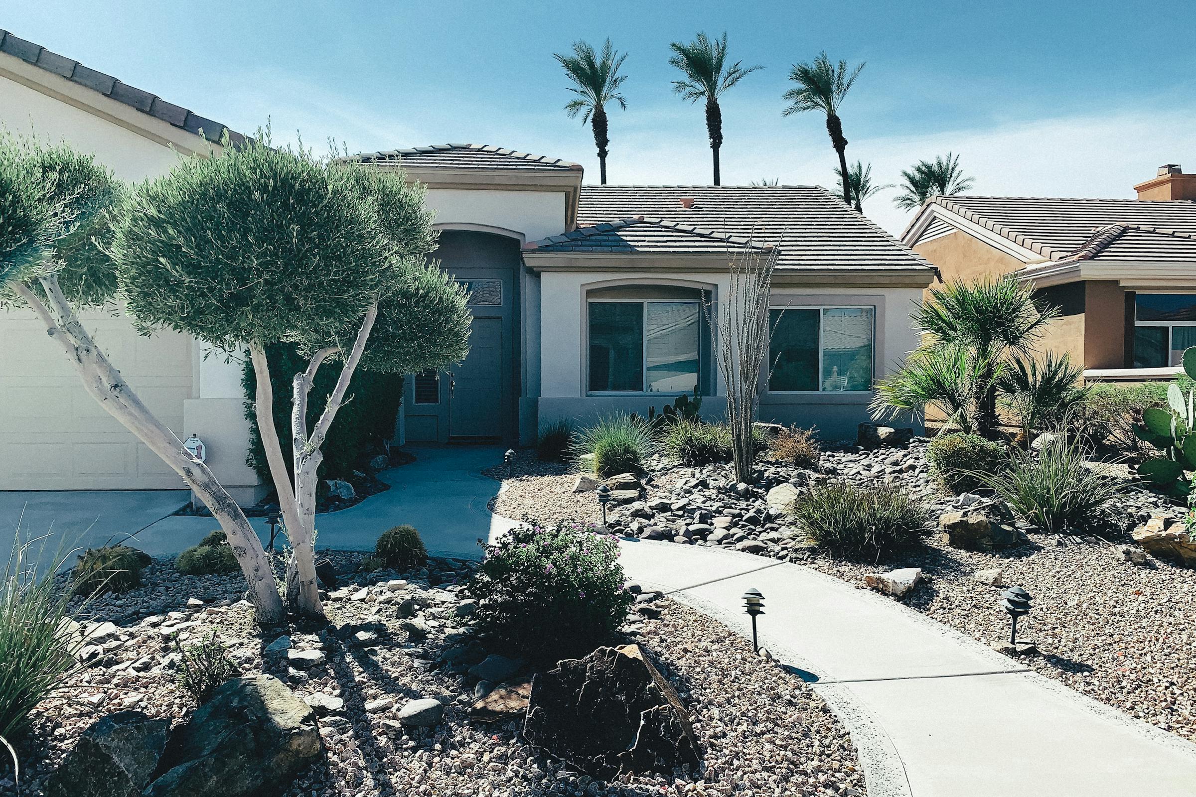 Lake-town home with skinned palms and gravel front, Lake Havasu City